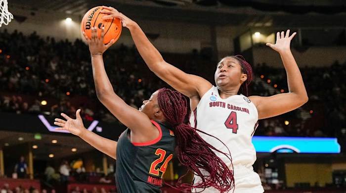 Aliyah Boston defending with her hand on the ball against Maryland’s Bri McDaniel
